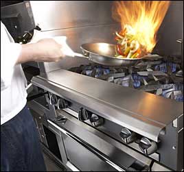 image of restaurant chef cooking over commercial gas range